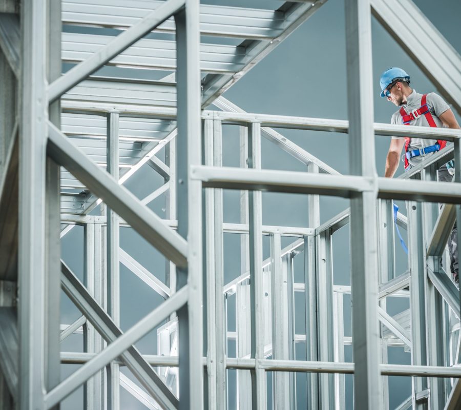 Caucasian Worker on the Skeleton Steel Building Construction. Industrial Theme.